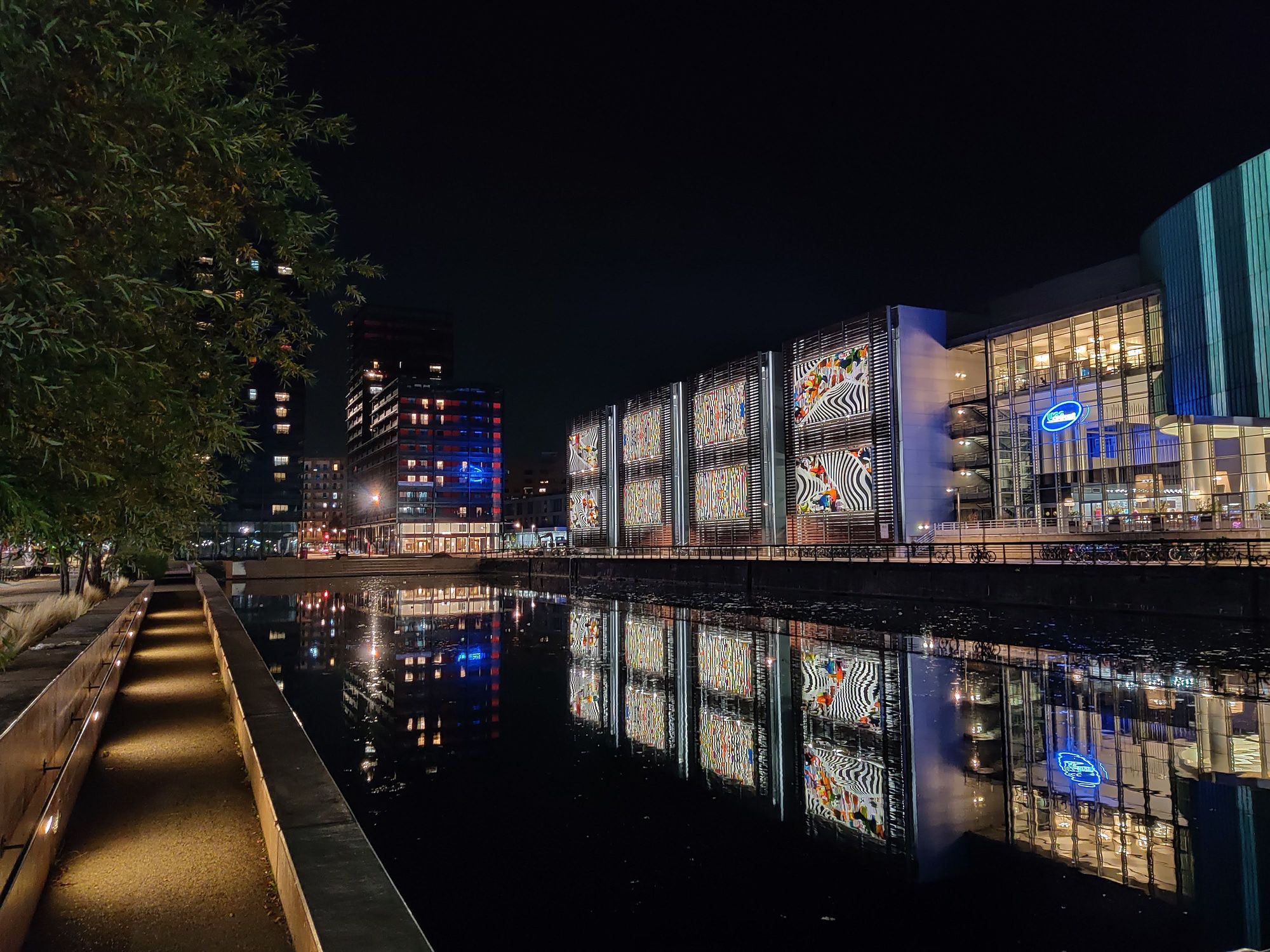 The UGC Cinéma at the edge of the Bassin d'Austerlitz, in Rivétoile quarter at night