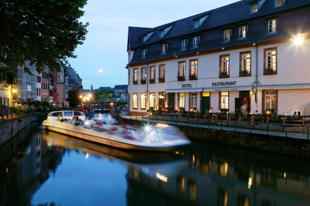 Batorama fly boat at night on the Ill River in La Petite France district in Strasbourg