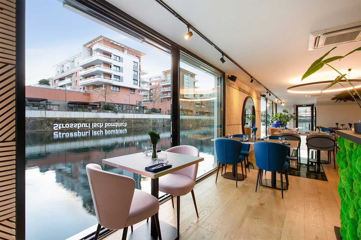 A restaurant on a floating boat in front of the shopping center Rivétoile in Strasbourg