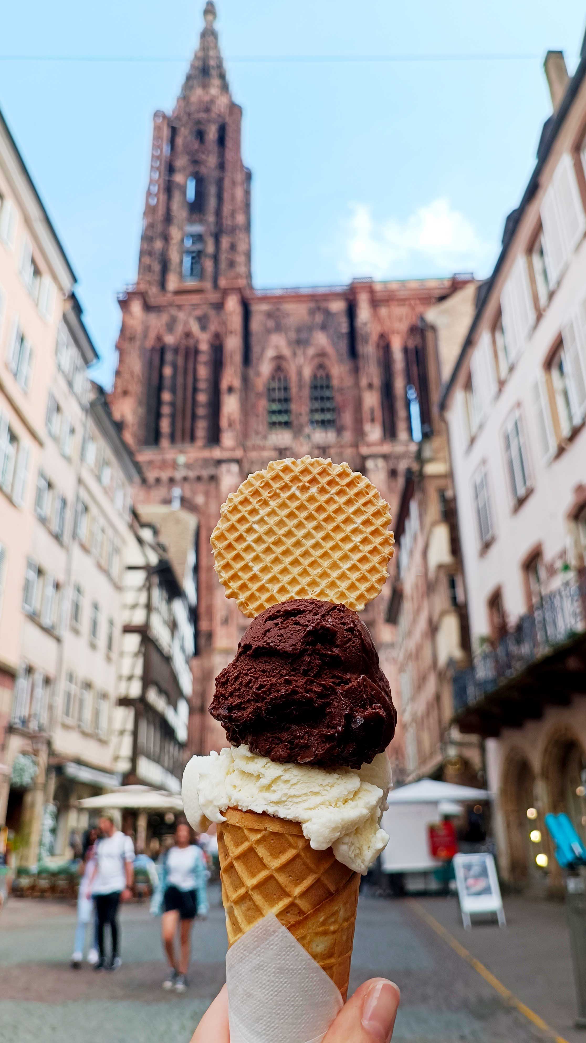 Chocolate and vanilla ice cream in front of the cathedral of Strasbourg