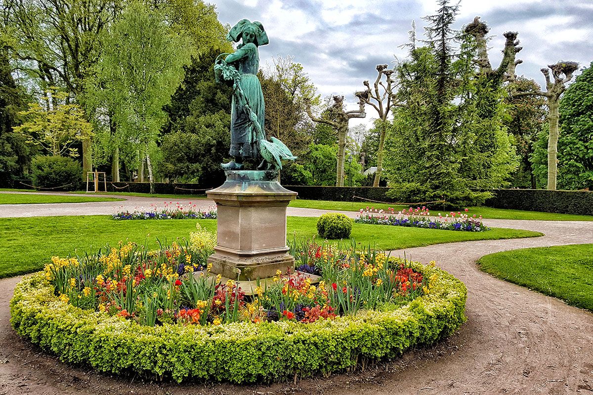 Statue of a peasant woman and her basket being chased by a goose