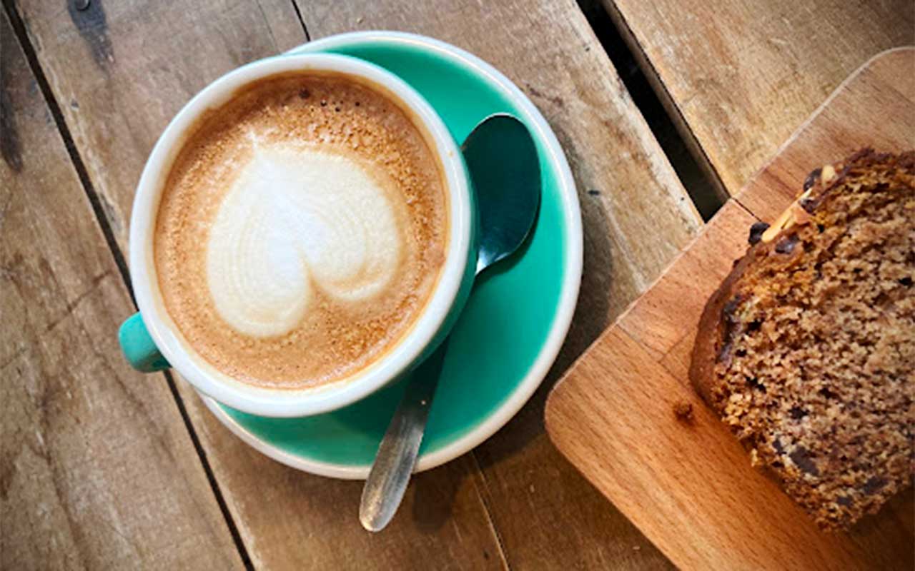 Cappuccino cup with a slice of homemade cake